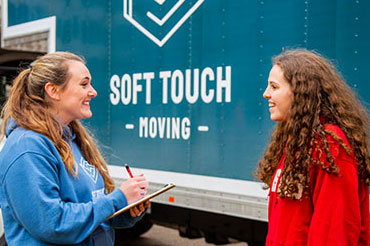 Soft Touch Moving professional working with a customer